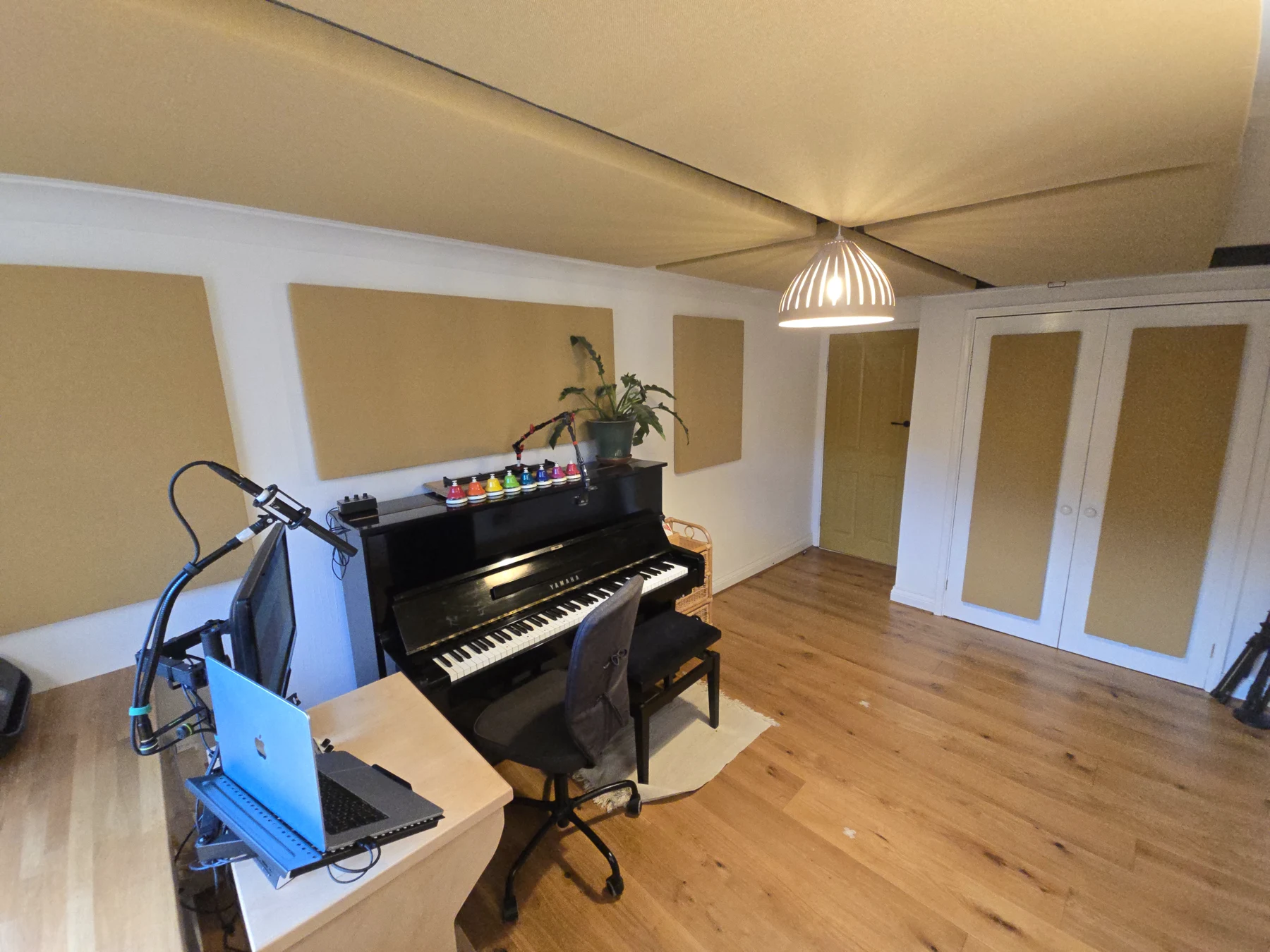 Music room with acoustic treatment panels fitted around a piano