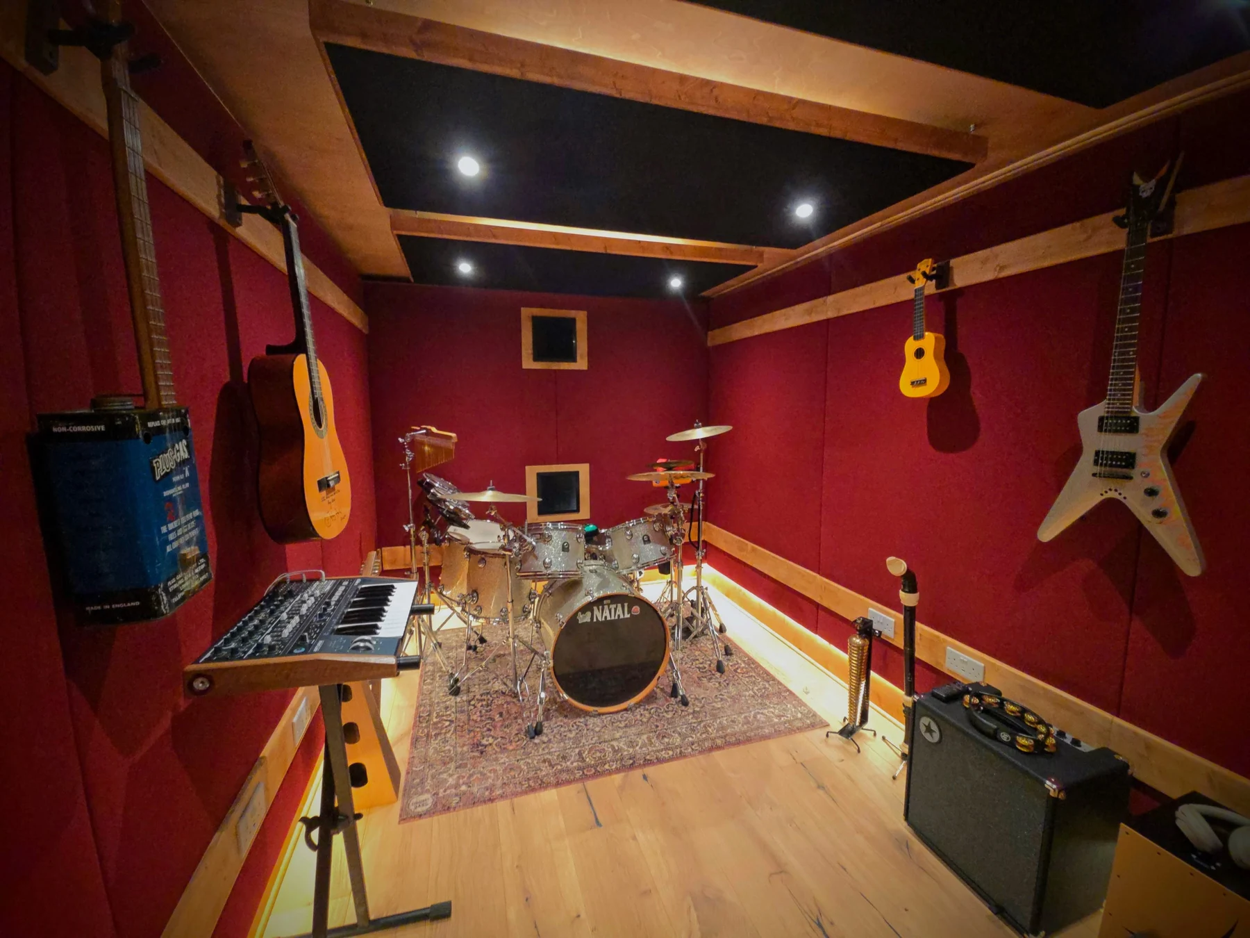 Soundproof rehearsal room with drums, guitars and acoustic treatment